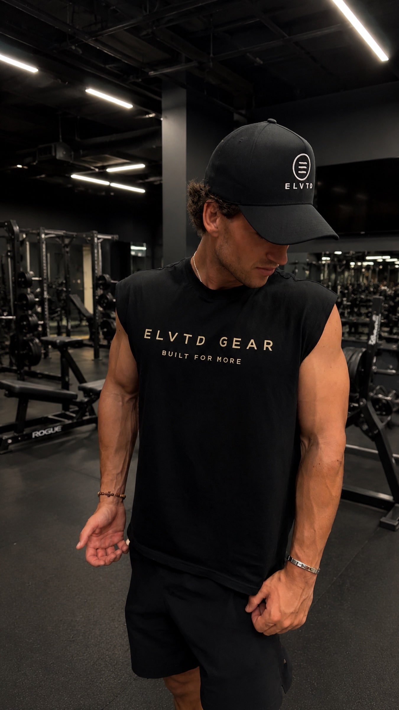 black ELVTD cut-off and cap in a dark gym