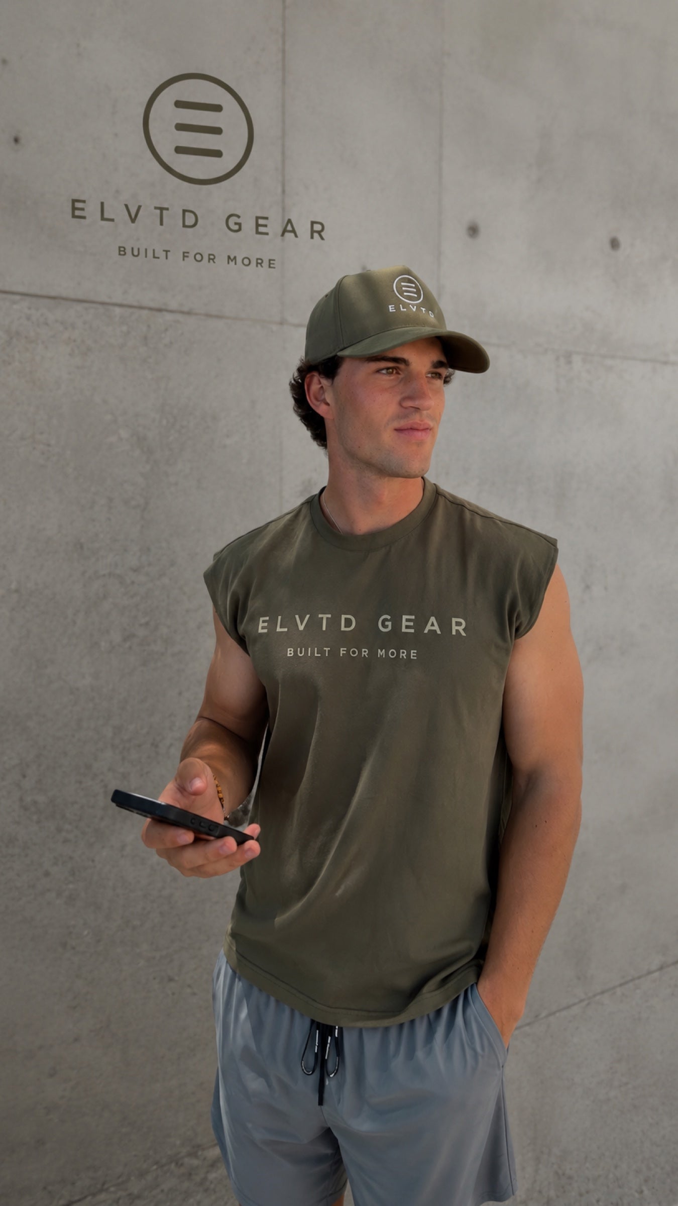 olive ELVTD cut-off and cap against branded concrete wall